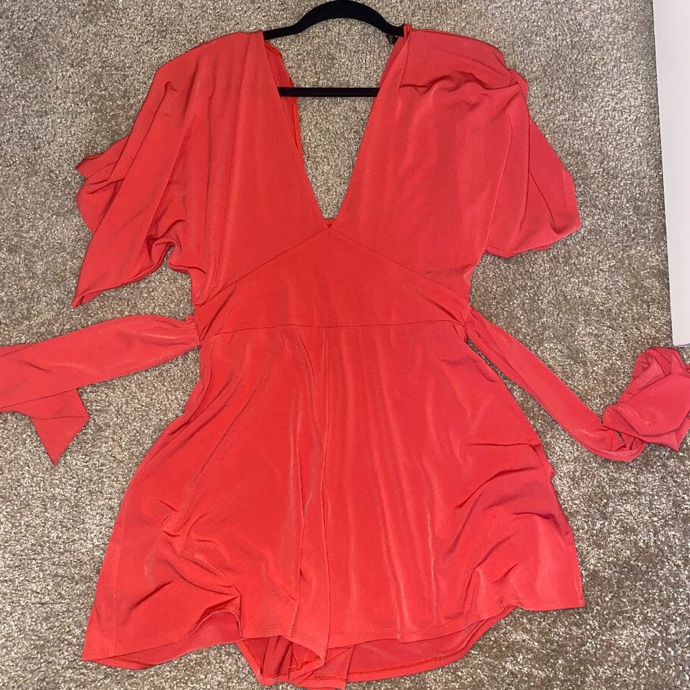 Express romper in a red/orange color, short sleeve with a wrap around, size S